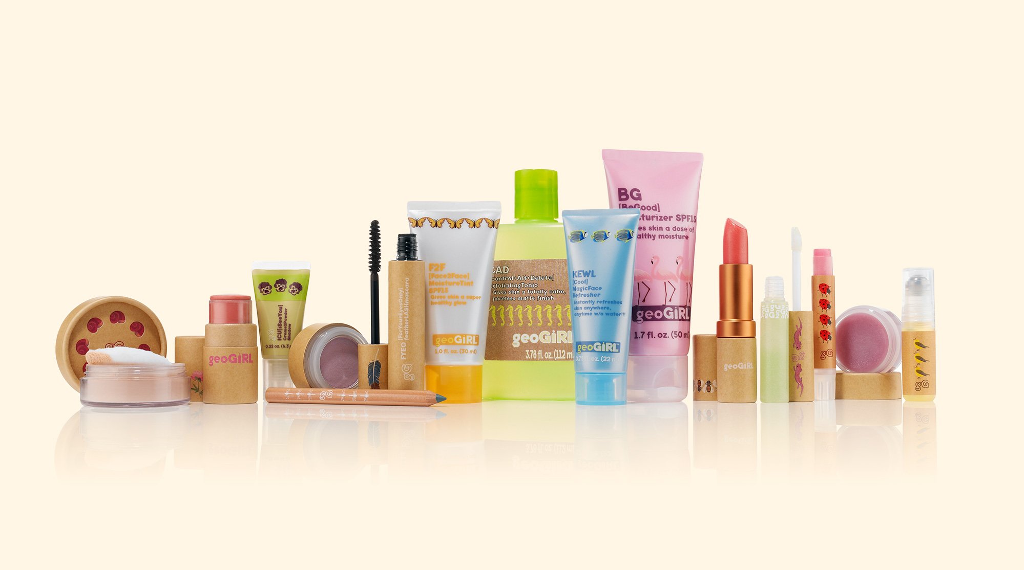 Collection of skincare and beauty products including lip balm, lip gloss, face moisturizer, face mist, eye shadows, pencils, and creams from geoGIRL with colorful packaging on a light background.
