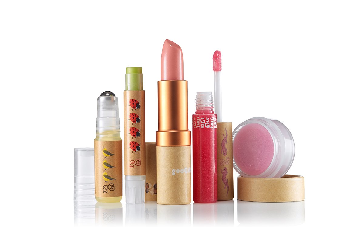 Collection of makeup products including lip balm, lipstick, lip gloss, and lip tint, with decorative packaging featuring ladybugs and worms.