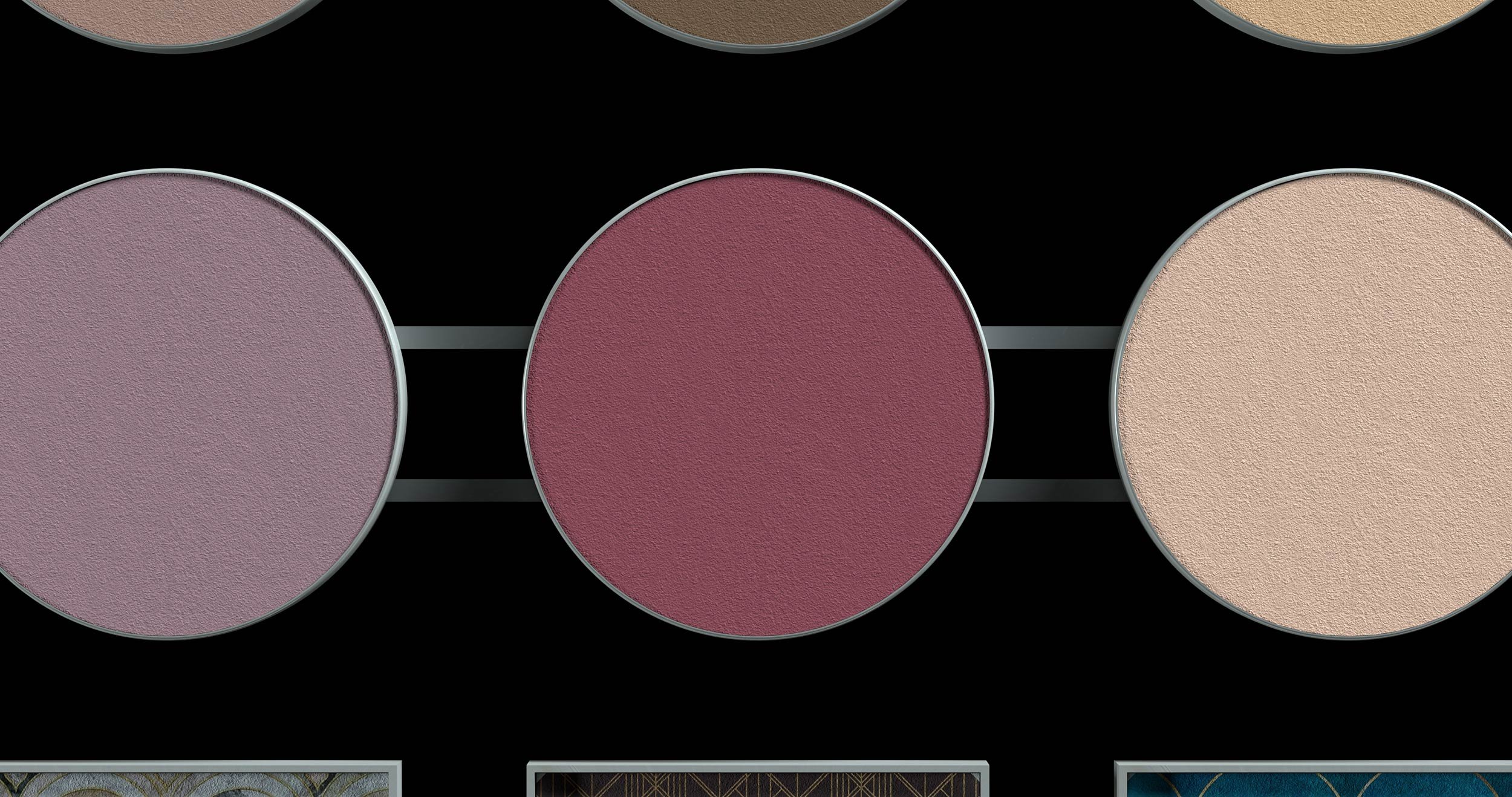 Close-up of three round makeup blush palettes in shades of purple, red, and beige against a black background.