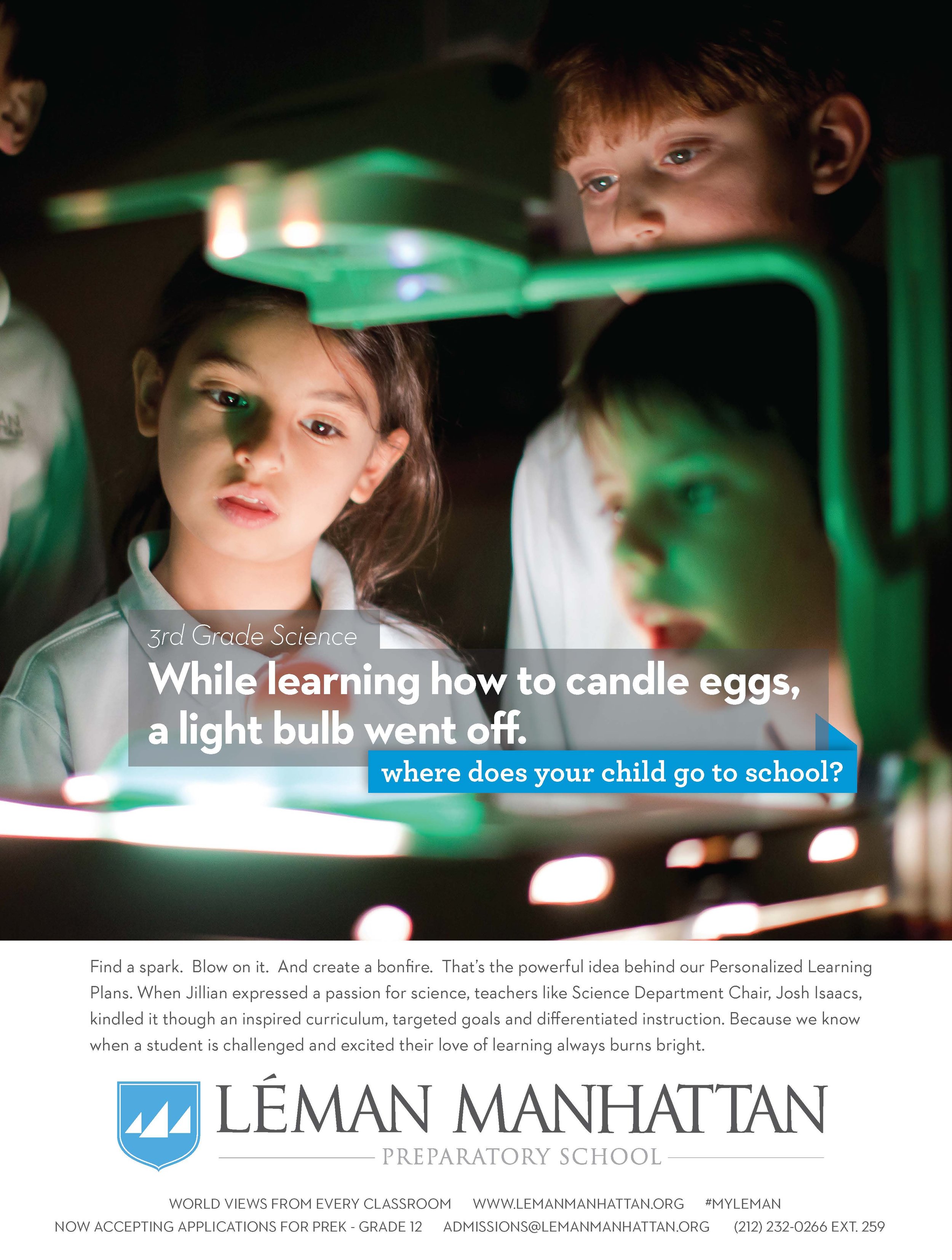 Three children looking at a science experiment involving a light bulb that has gone off, in a dark classroom.