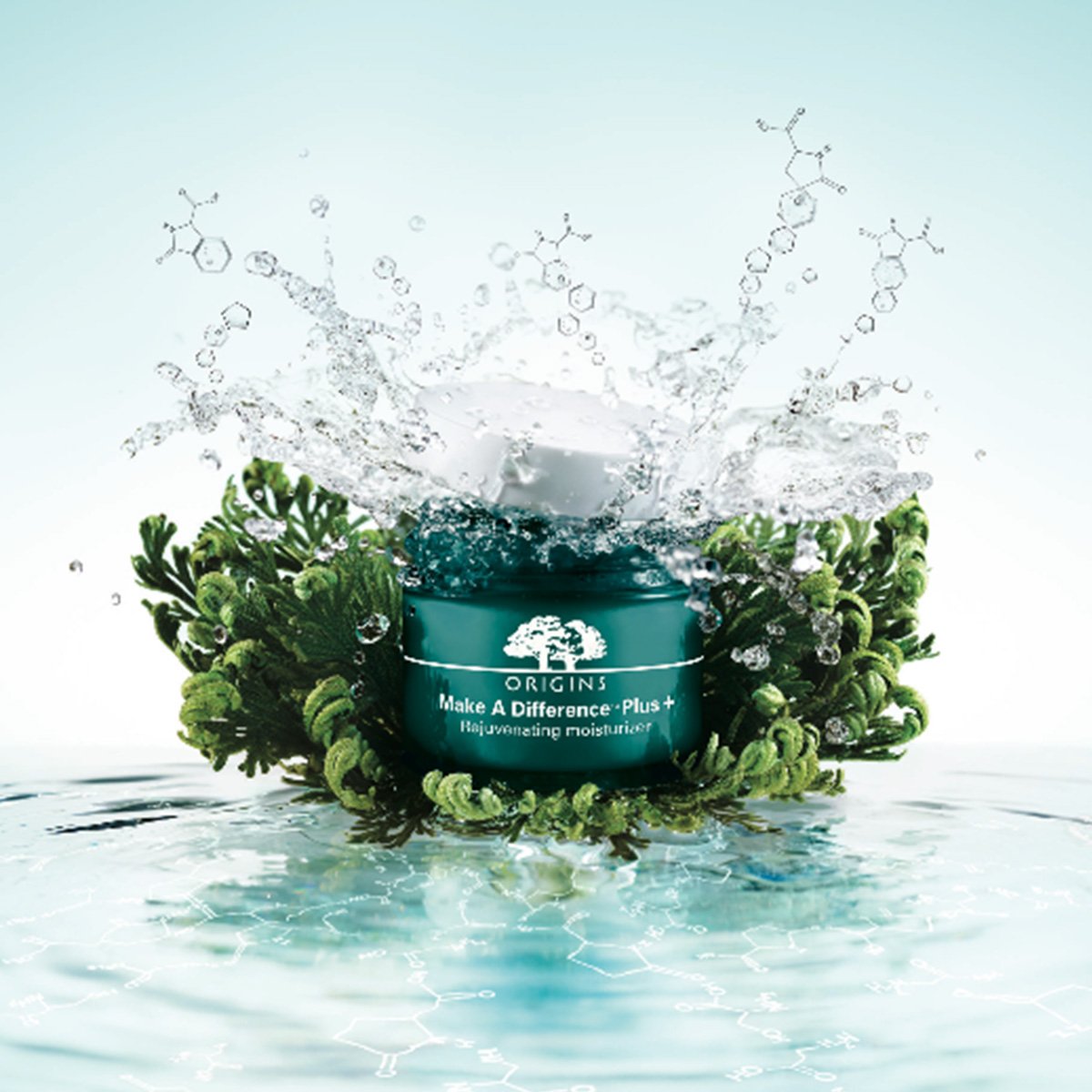 A blue jar of Origins Make A Difference Plus+ Hydrating Moisturizer surrounded by green botanicals, with water splashing and chemical structures in the background.