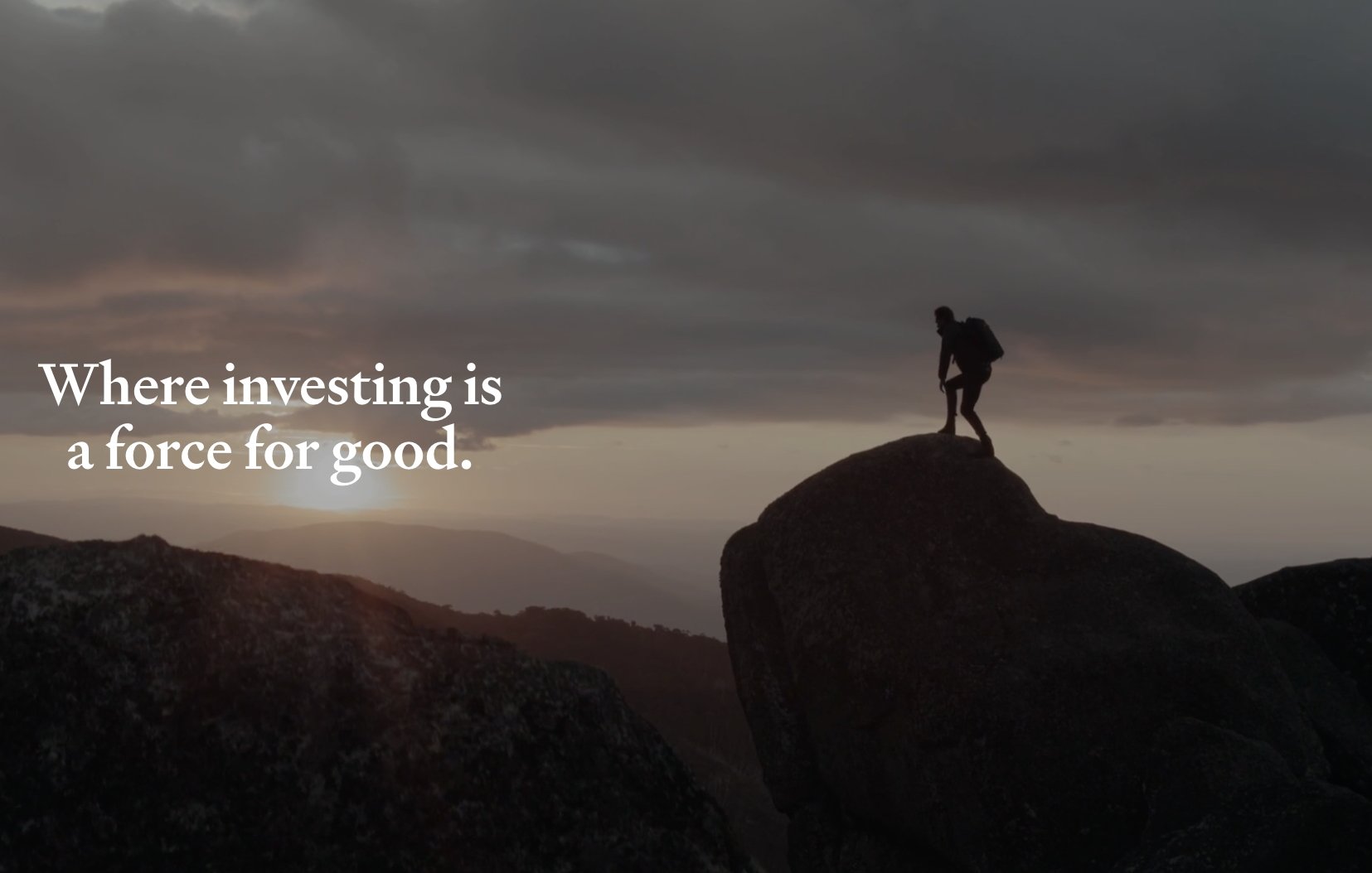 Silhouette of a hiker standing on a large rock at sunset or sunrise, with mountains and dark clouds in the background, and the text 'Where investing is a force for good' overlayed.